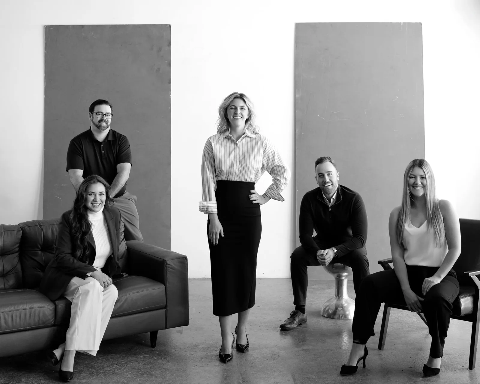 The Riverbend Appraisals team in the studio: Alexis Kelly on a leather sofa with Josh Ament behind her, Aryn Abbot standing, and Colin Abbot and Ashley Bradish seated